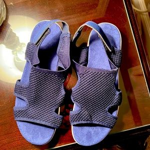Navy blue fabric sandals with Velcro back enclosure.
